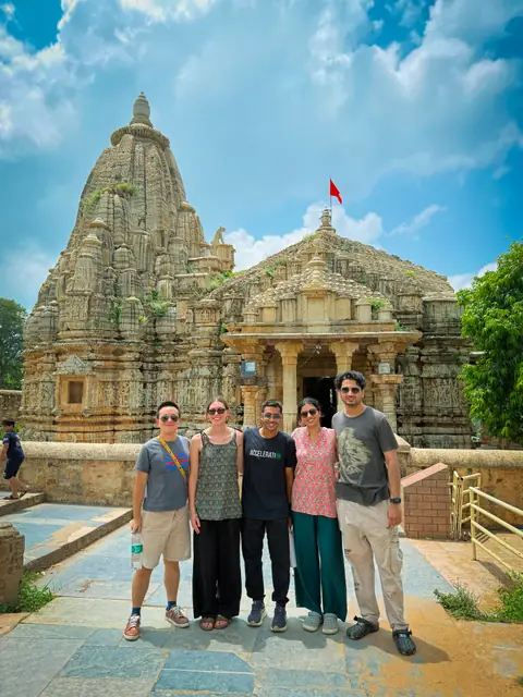 A group standing in the courtyard of a carved stone temple