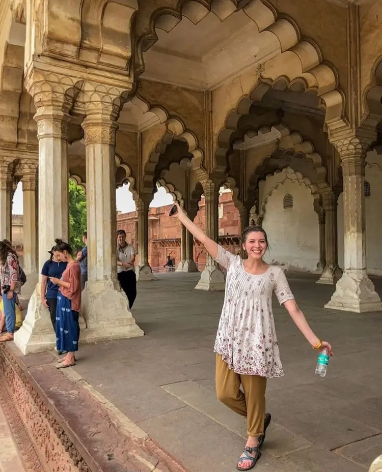 A traveller among the scalloped arches of the audience hall at Agra Fort
