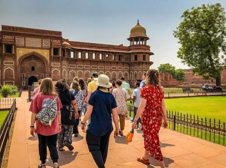 The group walking the red sandstone grounds inside Agra Fort