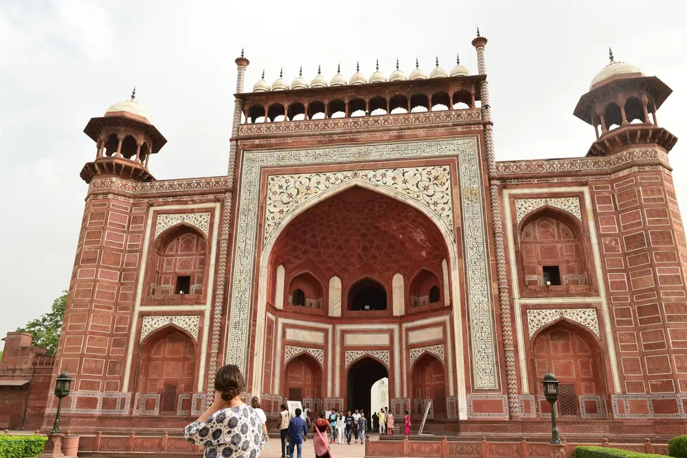 The great sandstone gateway to the Taj Mahal complex, with visitors beneath it