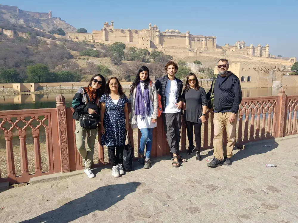 The group on a causeway with Amber Fort rising behind them